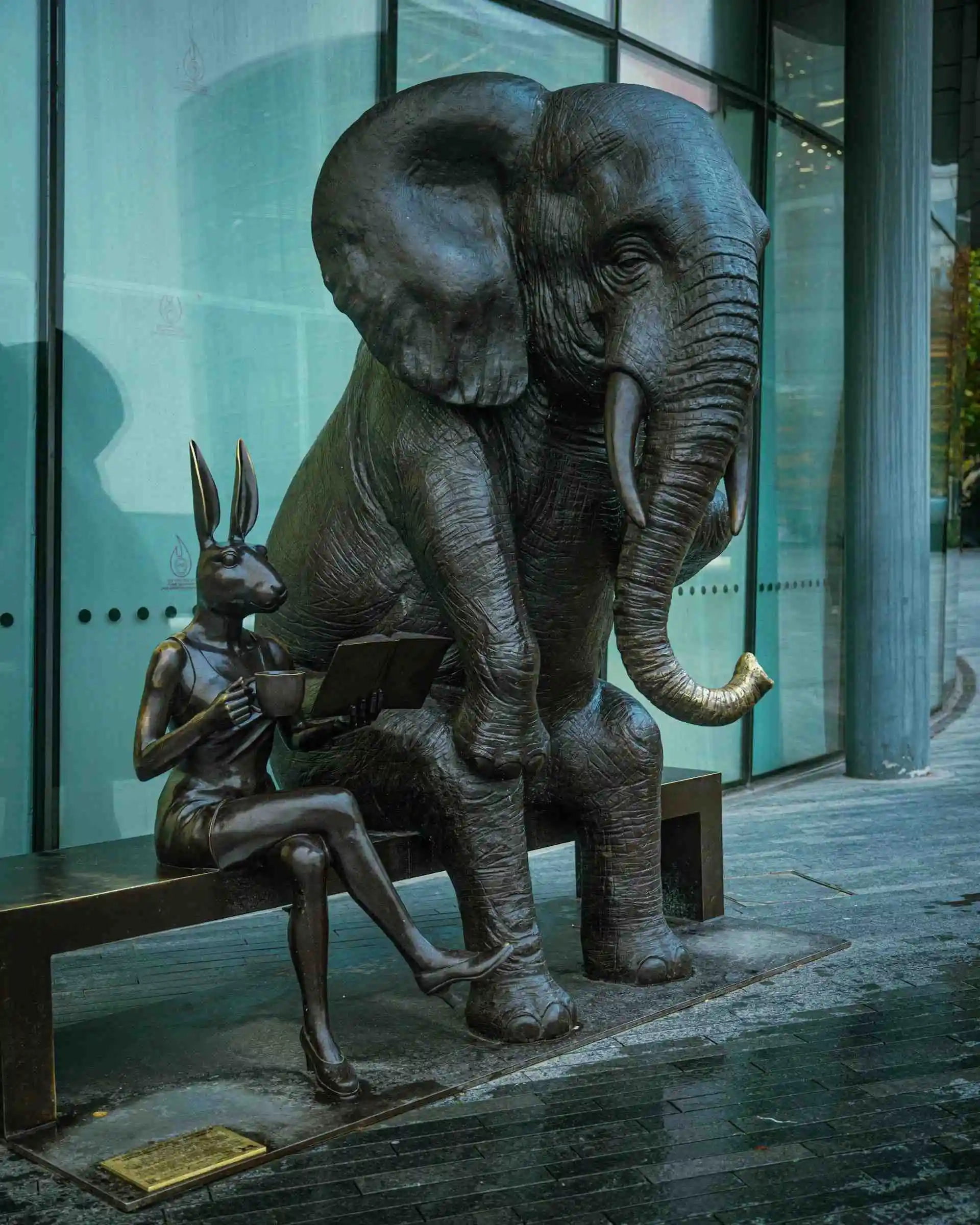 An elephant holds a coffee cup and talks to a rabbit. (Bronze Sculpture by Gillie and Marc currently on display near Tower Bridge in London)